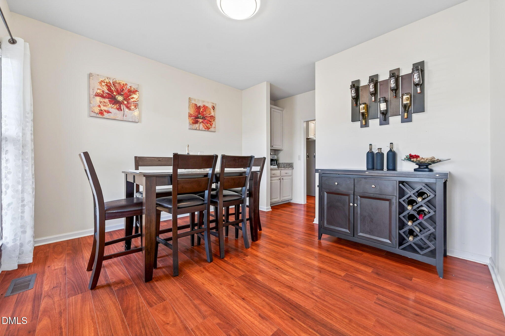708 Quiet Walk Circle Rolesville, NC 27571 - Photo 4 of 56 a view of a dining room with furniture and wooden floor