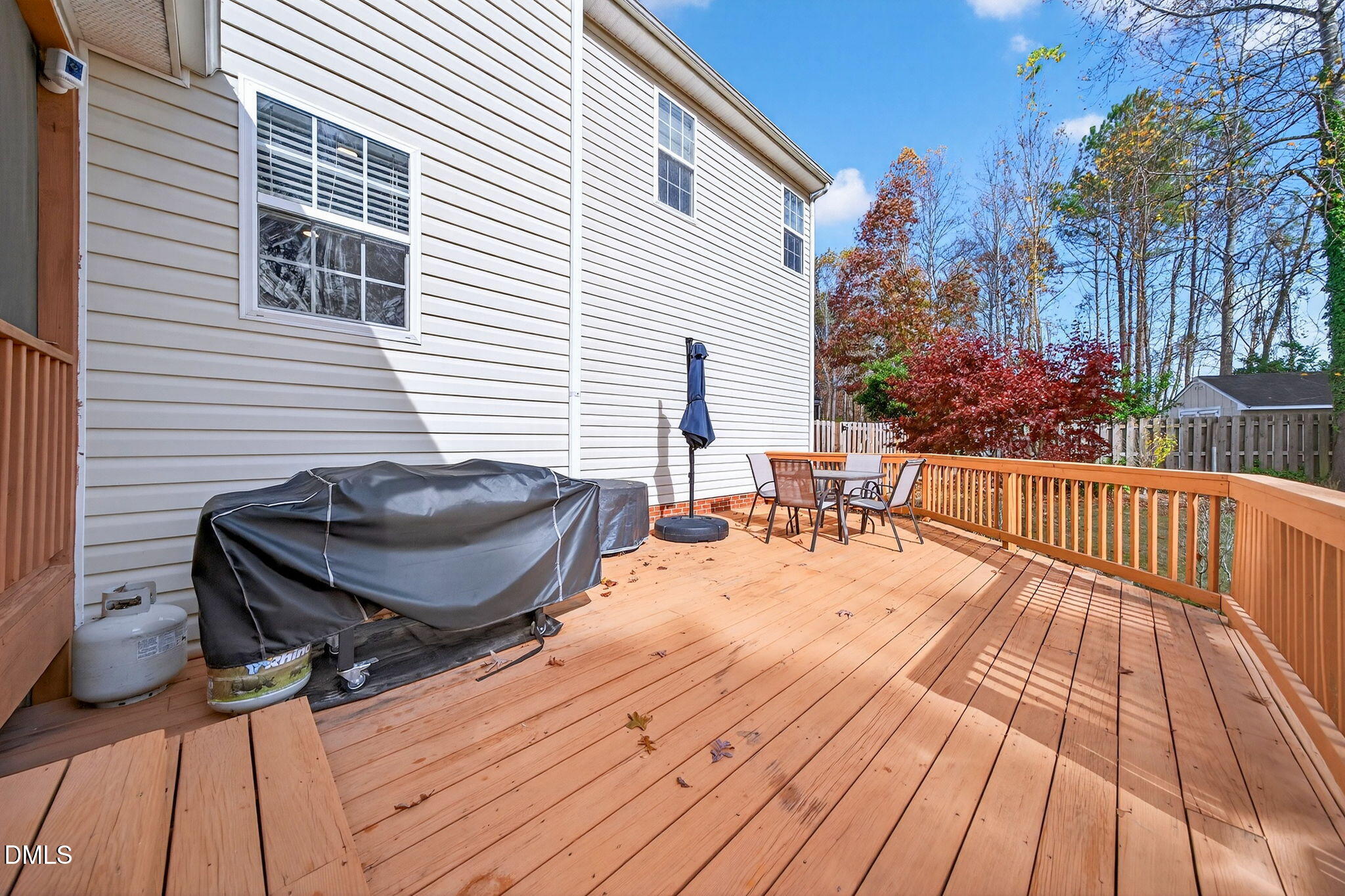 708 Quiet Walk Circle Rolesville, NC 27571 - Photo 43 of 56 a view of a roof deck with table and chairs and wooden floor