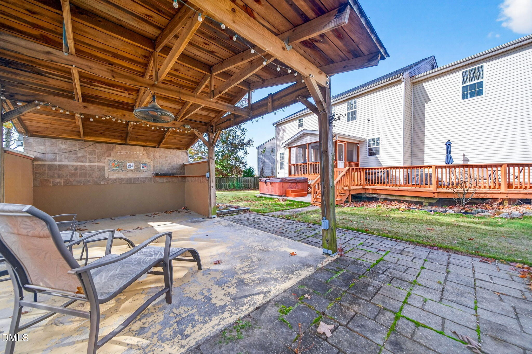 708 Quiet Walk Circle Rolesville, NC 27571 - Photo 49 of 56 a backyard of a house with barbeque oven table and chairs