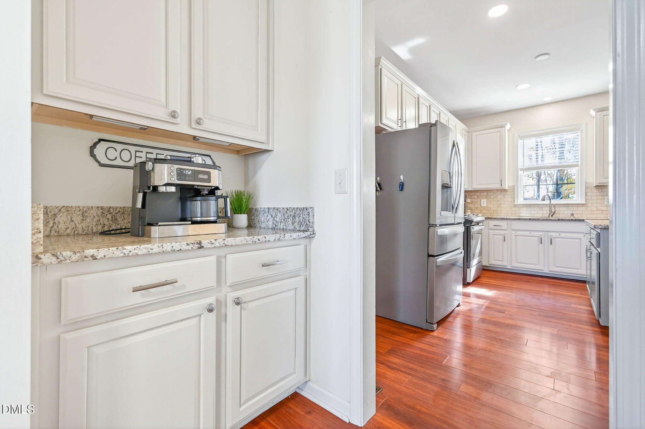 708 Quiet Walk Circle Rolesville, NC 27571 - Photo 5 of 56 a kitchen with stainless steel appliances granite countertop a refrigerator and cabinets