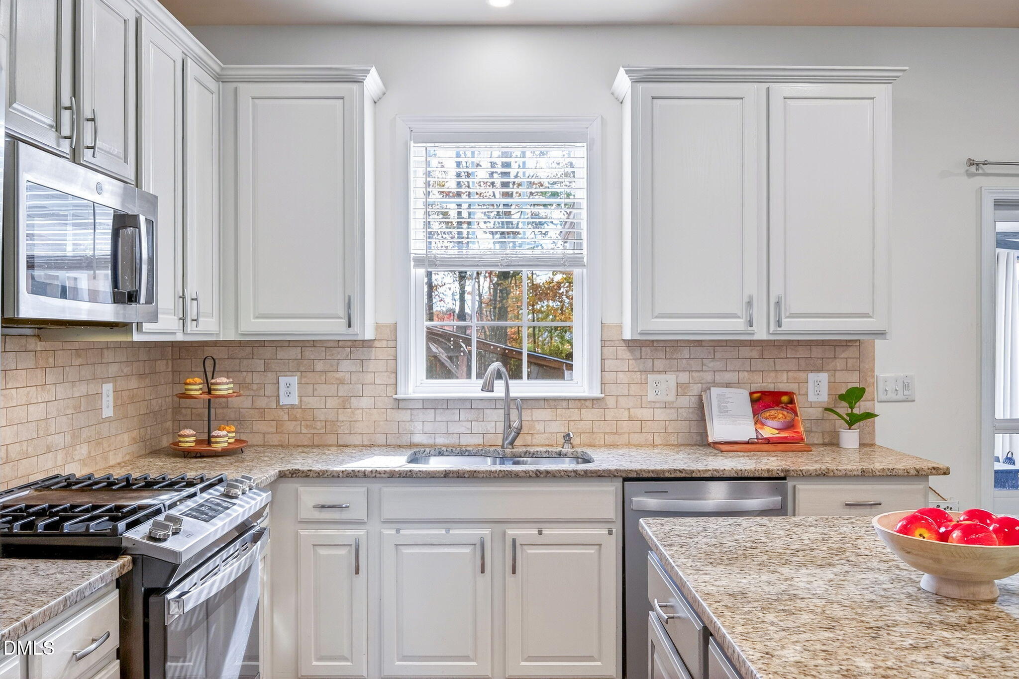 708 Quiet Walk Circle Rolesville, NC 27571 - Photo 7 of 56 a kitchen with granite countertop a sink stove and cabinets