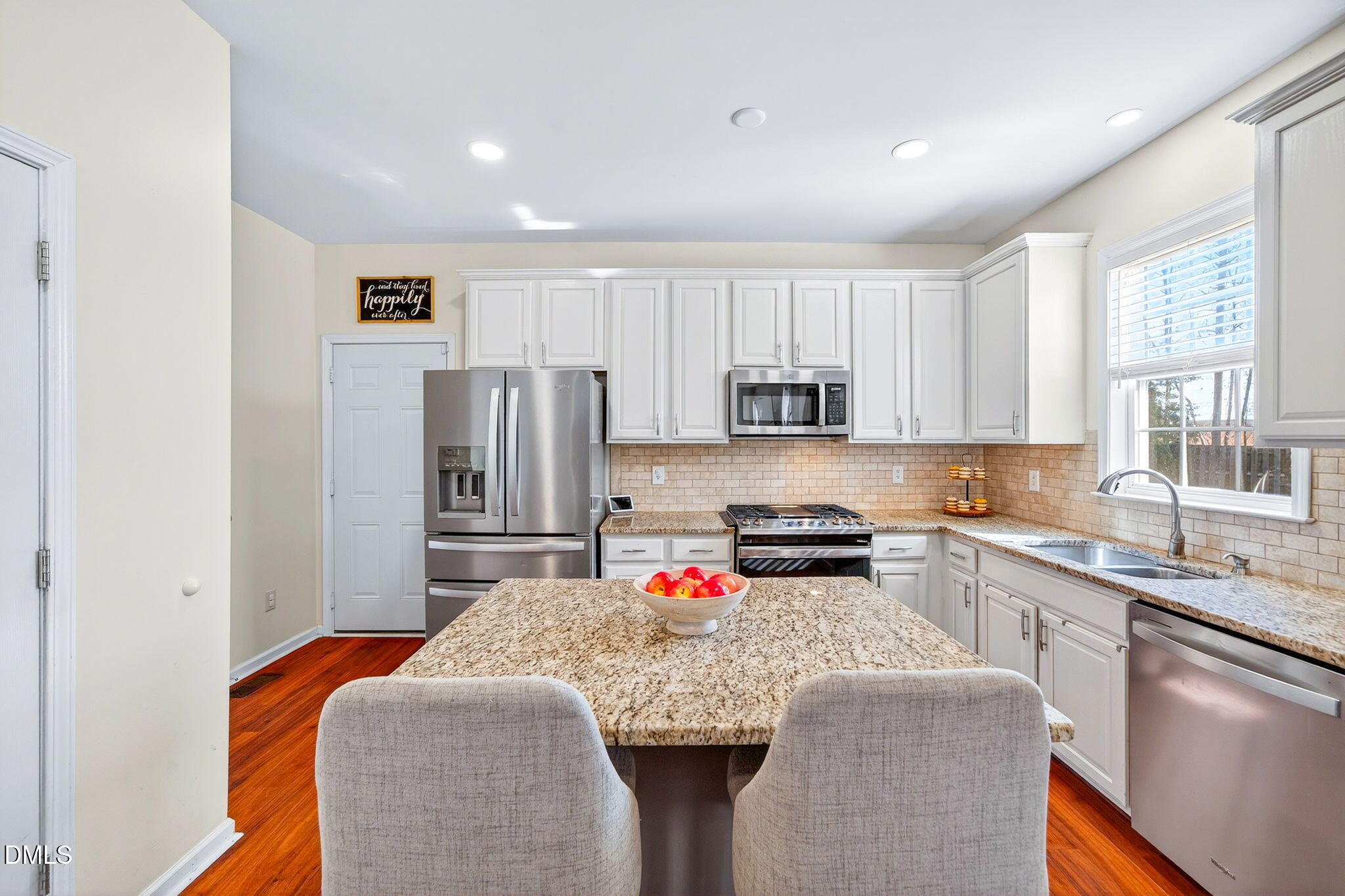 708 Quiet Walk Circle Rolesville, NC 27571 - Photo 9 of 56 a kitchen with stainless steel appliances granite countertop a sink stove and refrigerator