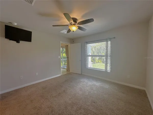 a view of a livingroom with a ceiling fan and window