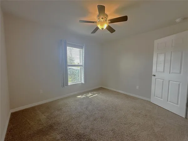 a view of an empty room and closet area