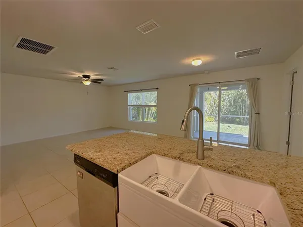 a bathroom with a granite countertop sink and a bathtub