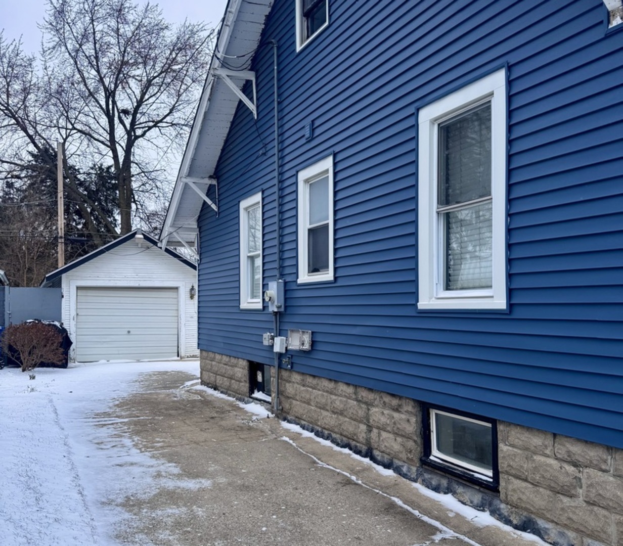 807 Spruce Street Aurora, IL 60506 - Photo 18 of 20 a view of a house with a yard and garage