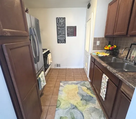 a bathroom with a sink a toilet a window and vanity