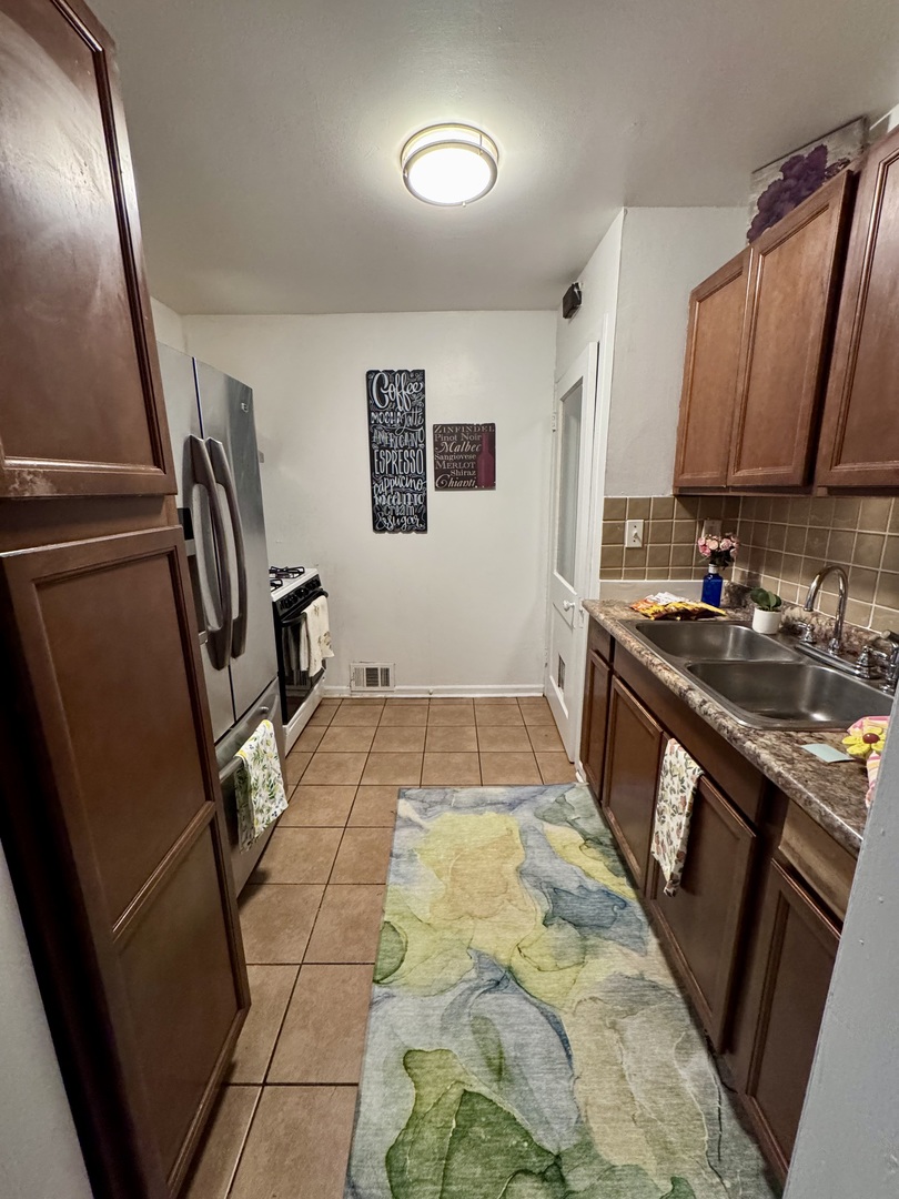 807 Spruce Street Aurora, IL 60506 - Photo 7 of 20 a bathroom with a sink a mirror and a toilet