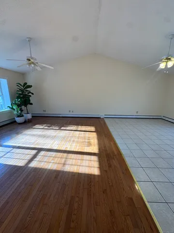 a view of an empty room and wooden floor