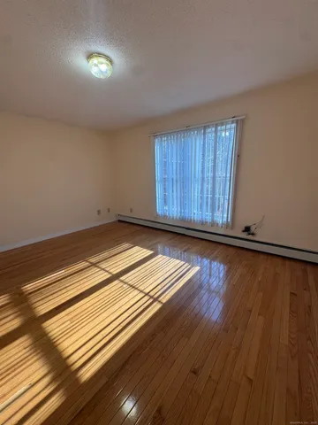 a view of a room with wooden floor and staircase