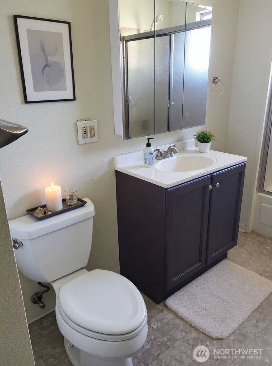 8854 Interlake Avenue North Seattle, WA 98103 - Photo 17 of 23 a bathroom with a toilet sink and mirror