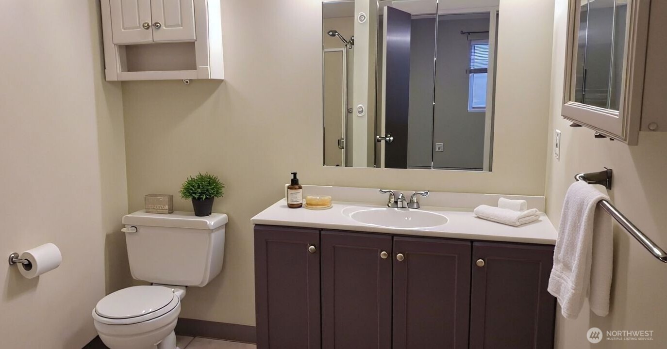 8854 Interlake Avenue North Seattle, WA 98103 - Photo 18 of 23 a bathroom with a toilet sink and mirror