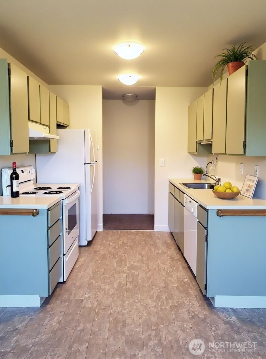 8854 Interlake Avenue North Seattle, WA 98103 - Photo 8 of 23 a kitchen that has a lot of cabinets in it and appliances