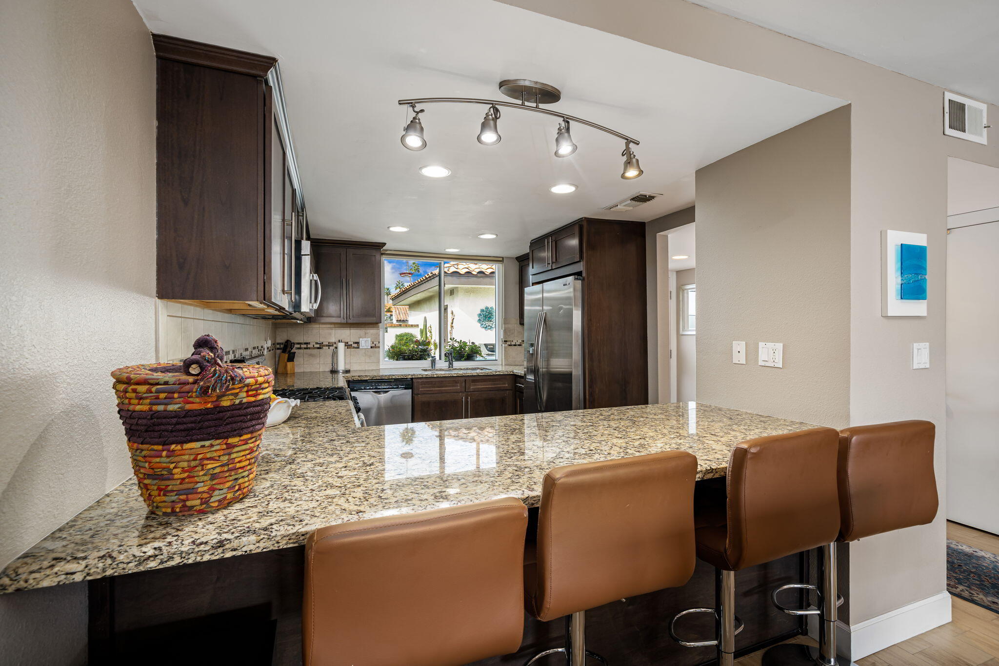 21 Toledo Drive Rancho Mirage, CA 92270 - Photo 13 of 35 a kitchen with granite countertop a sink and cabinets