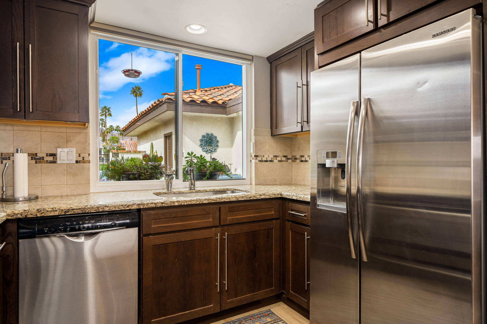 21 Toledo Drive Rancho Mirage, CA 92270 - Photo 15 of 35 a kitchen with stainless steel appliances a sink and a refrigerator