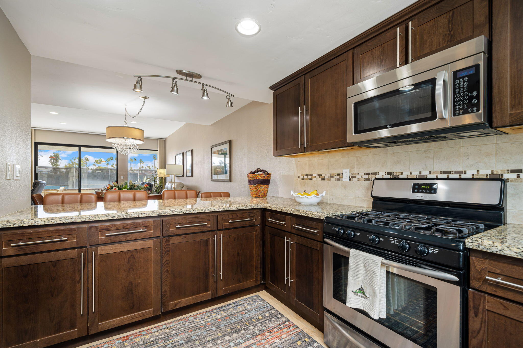 21 Toledo Drive Rancho Mirage, CA 92270 - Photo 16 of 35 a kitchen with stainless steel appliances granite countertop a sink and a stove