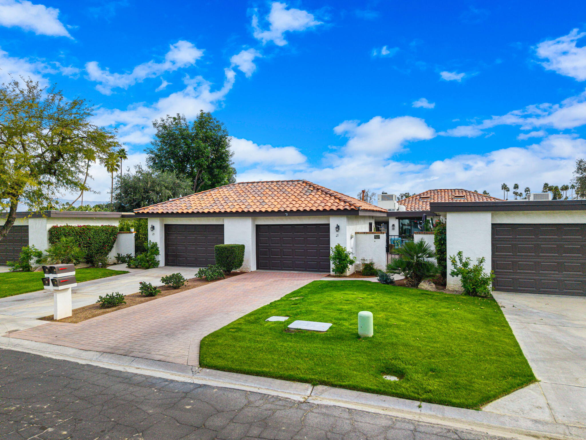 21 Toledo Drive Rancho Mirage, CA 92270 - Photo 2 of 35 a front view of a house with a yard and garage