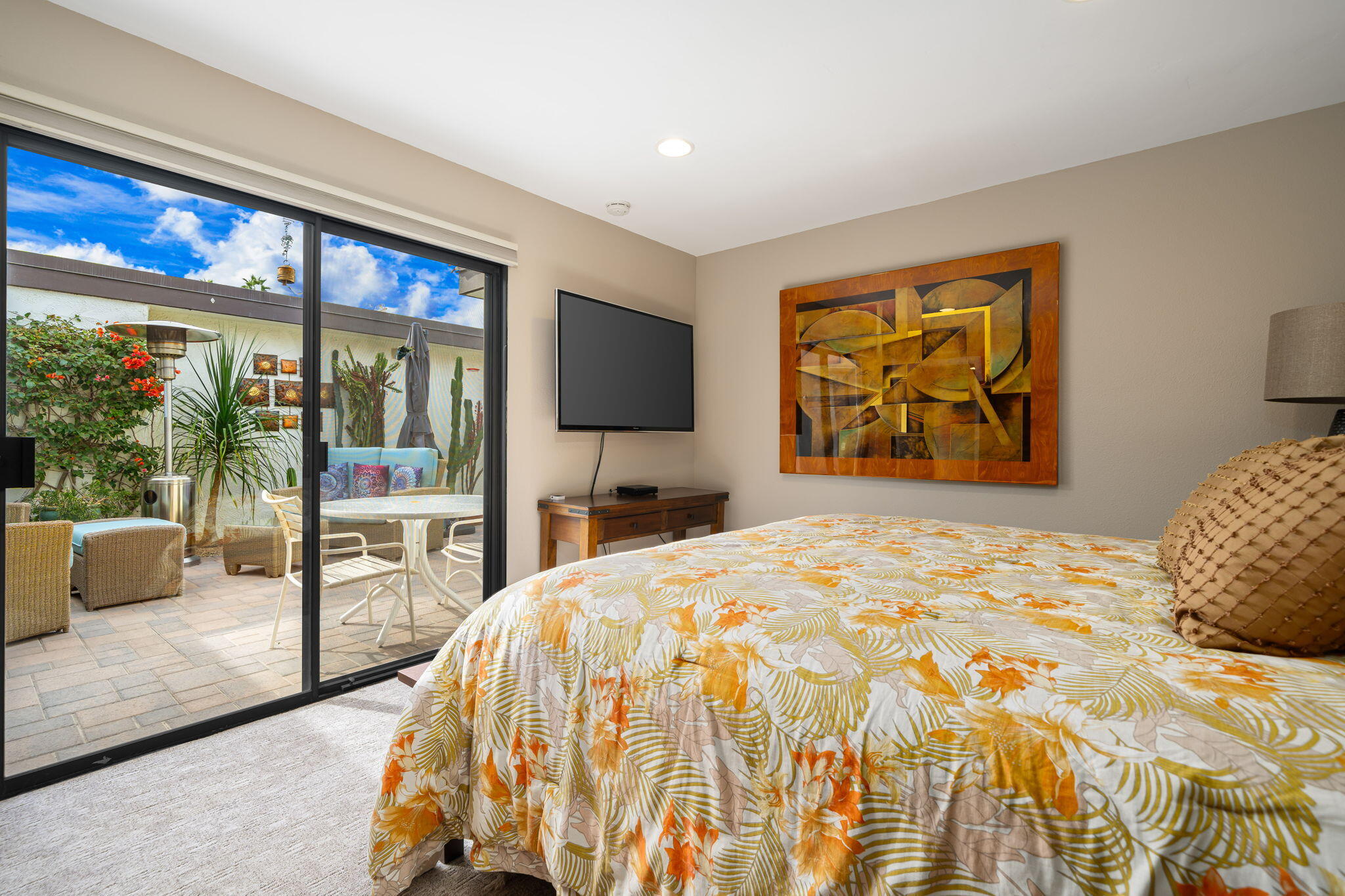 21 Toledo Drive Rancho Mirage, CA 92270 - Photo 23 of 35 a bedroom with a bed and glass wall