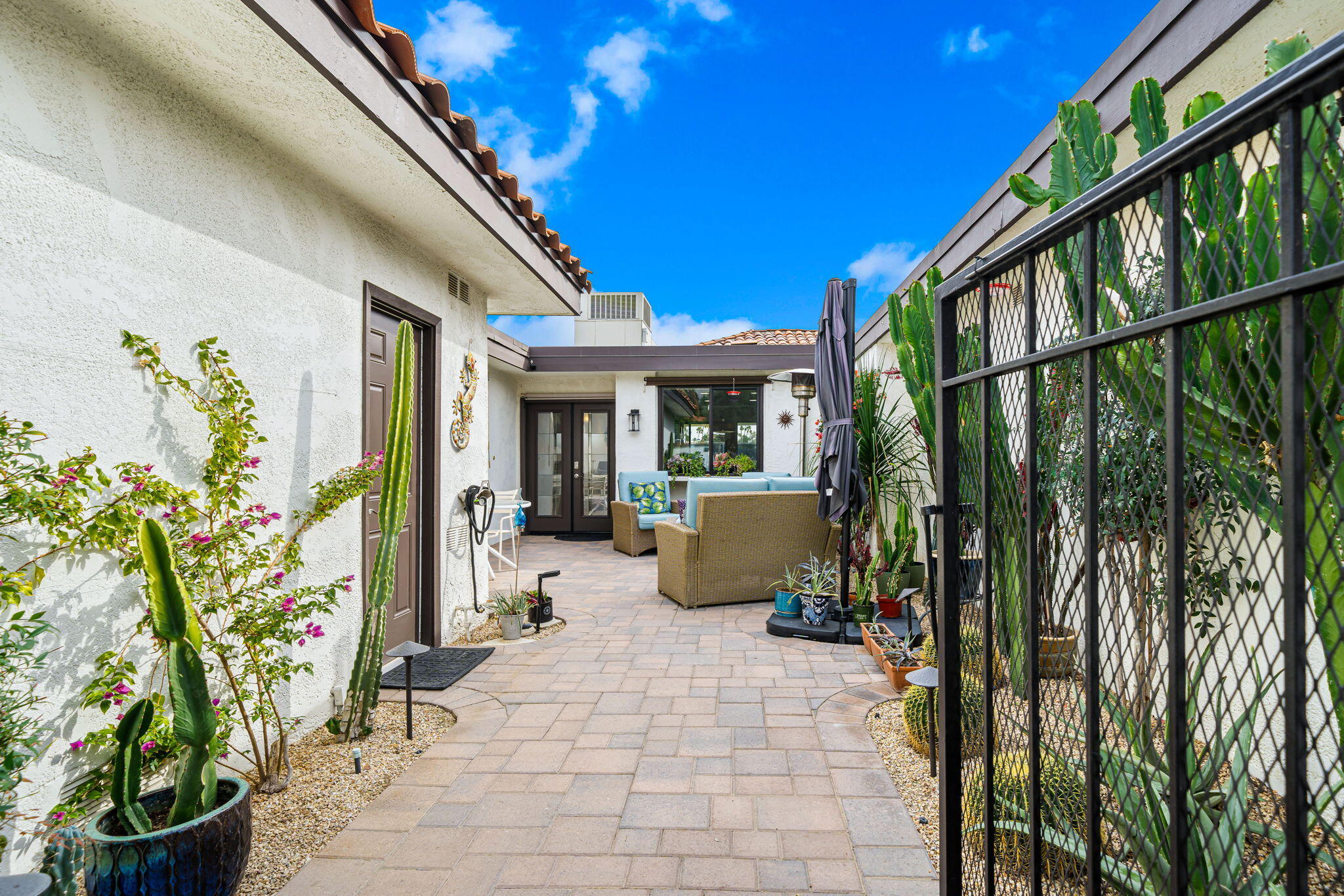 21 Toledo Drive Rancho Mirage, CA 92270 - Photo 4 of 35 a view of a patio with chairs and potted plants