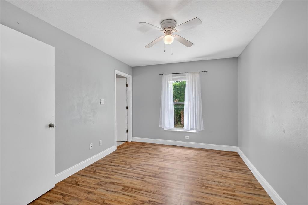 36 Bay Ridge Loop Mascotte, FL 34753 - Photo 18 of 32 wooden floor in an empty room with a window