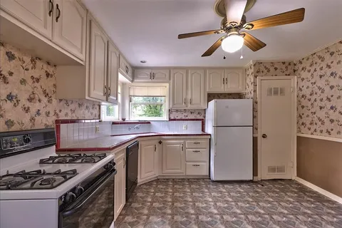 a kitchen with a stove a sink and a refrigerator