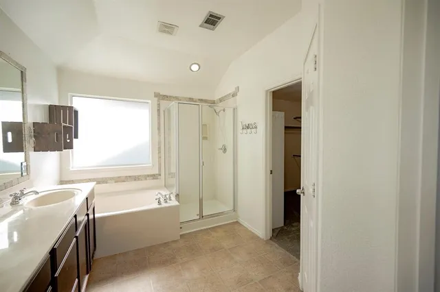a bathroom with a double vanity sink a mirror and a shower