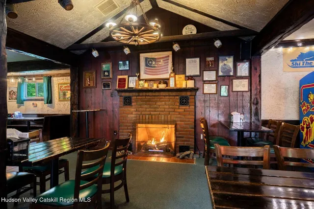 a room with furniture pool table table and chairs