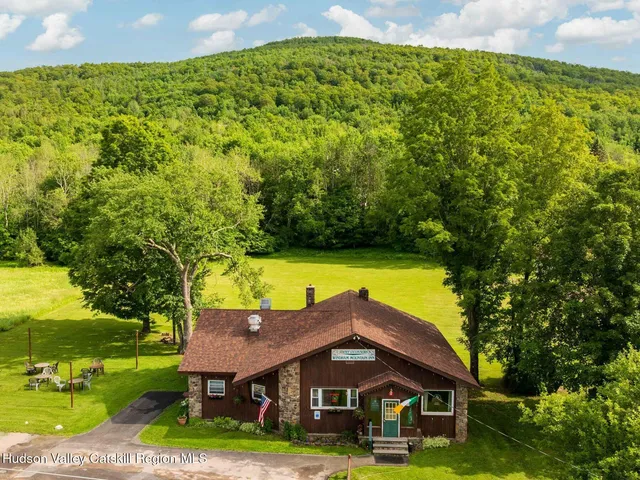 an aerial view of a house with swimming pool garden and patio