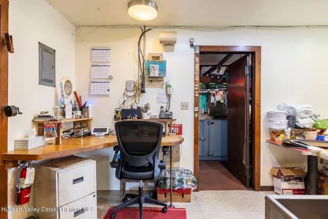 a storage utility room with a sink and cabinets