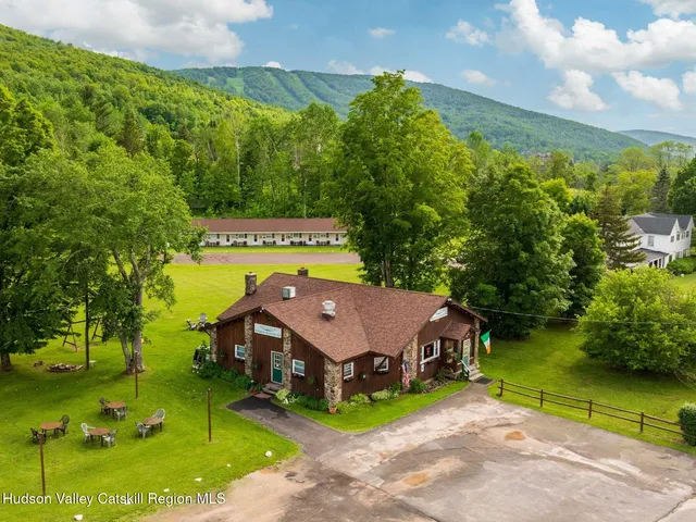 a front view of a house with a yard and trees