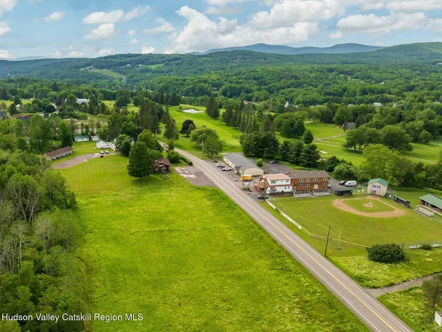a view of a house with a yard patio and a slide