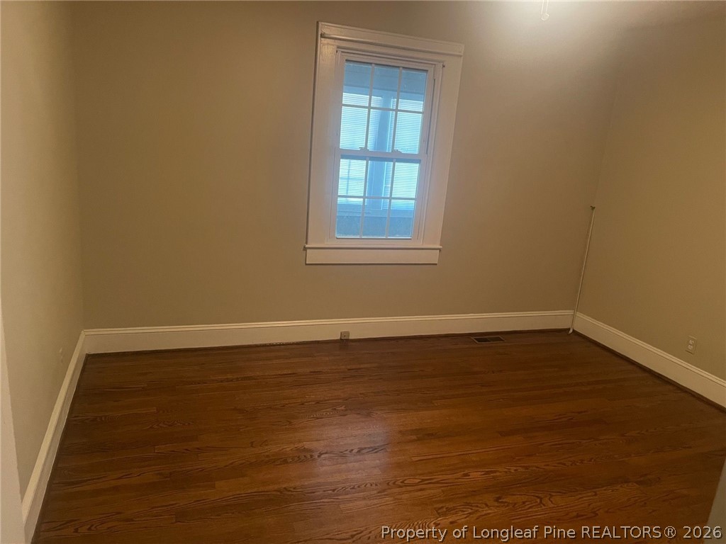 2515 Fort Bragg Road Fayetteville, NC 28303 - Photo 11 of 23 a view of an empty room with wooden floor and a window