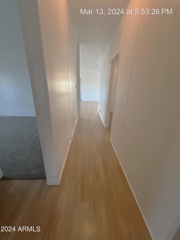 a view of gallery with wooden floor