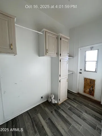 a view of a room with wooden floor and cabinet