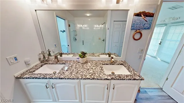 a bathroom with a granite countertop sink a toilet and a mirror
