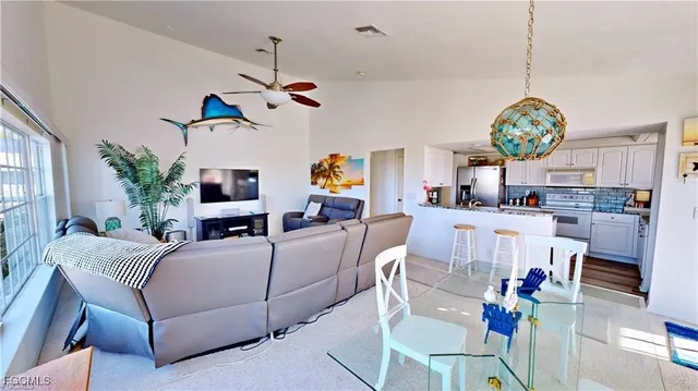 a living room with kitchen furniture and a chandelier