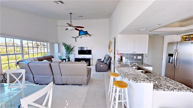 a living room with furniture fireplace and flat screen tv