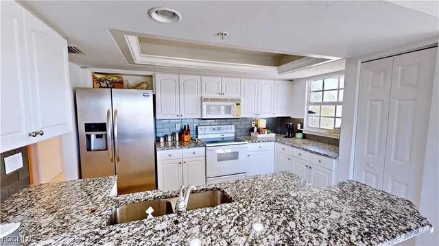 a kitchen with a refrigerator and a sink