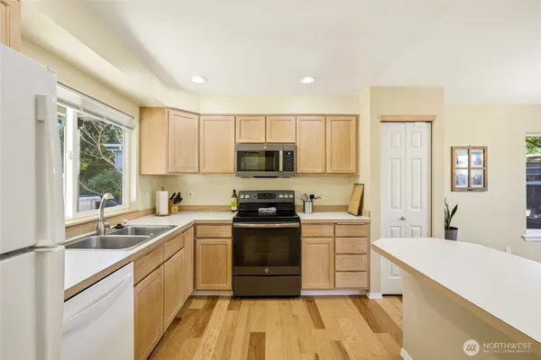 a kitchen with a sink stainless steel appliances and cabinets