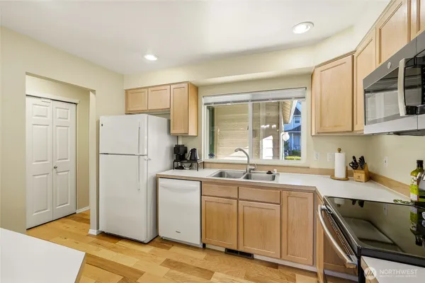 a kitchen with a refrigerator a sink and cabinets