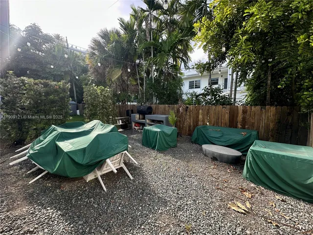 a view of a chair and tables in the patio