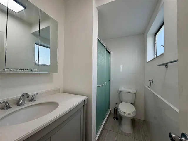 a white toilet sitting next to a bathroom sink