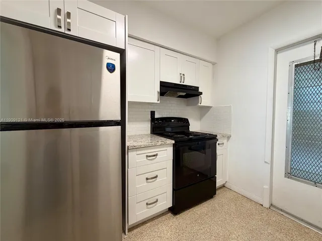 a kitchen with stainless steel appliances a refrigerator and a stove