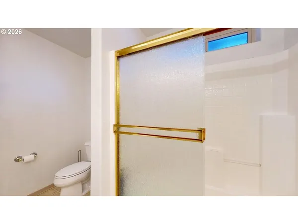 a bathroom with a toilet and a shower curtain