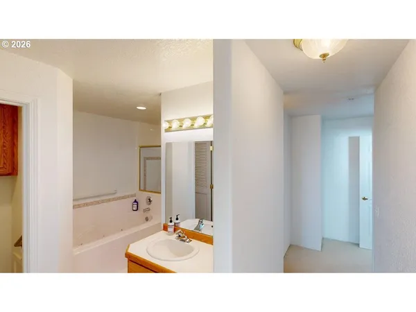 a bathroom with a tub and a sink