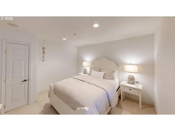 a bedroom with a bed and a night stand