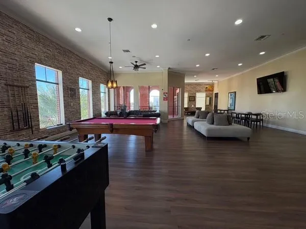 a living room with lots of furniture and kitchen view