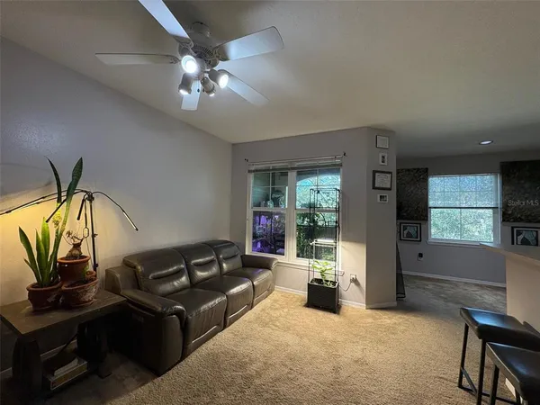 a living room with furniture and a chandelier