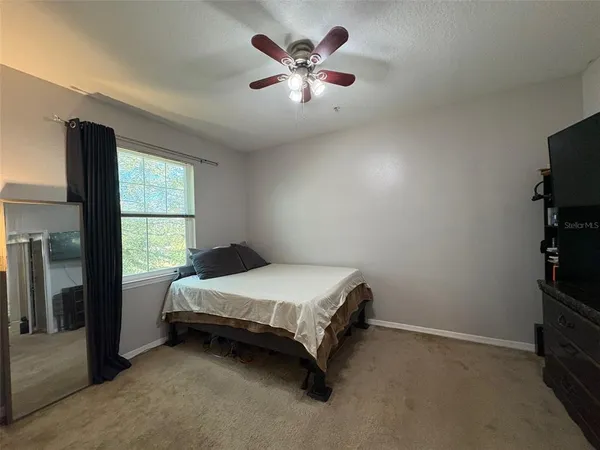 a bedroom with a bed and window