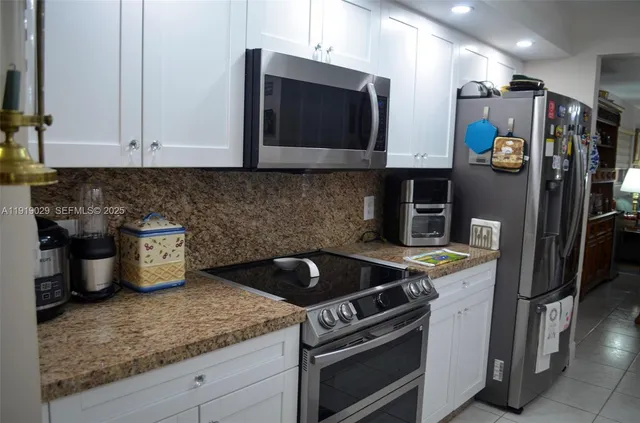 a kitchen with a stove and a microwave